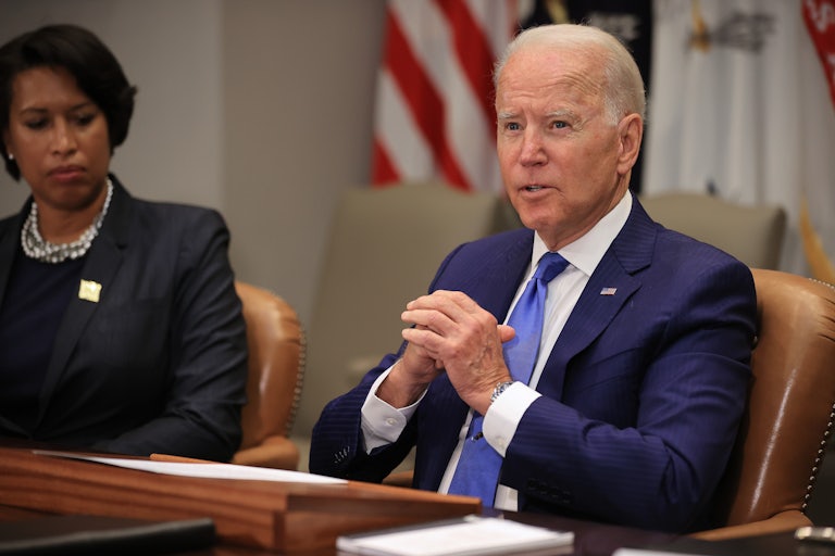 Biden and Bowser sit at a table.